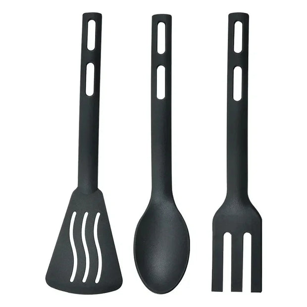 Set of three black kitchen utensils on a white background