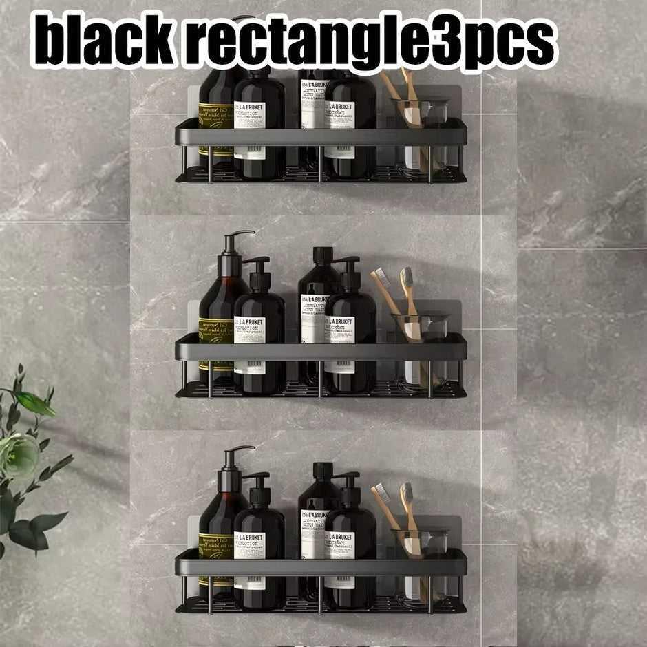 Three black rectangular wall shelves with various bottles and items on a gray tiled wall.