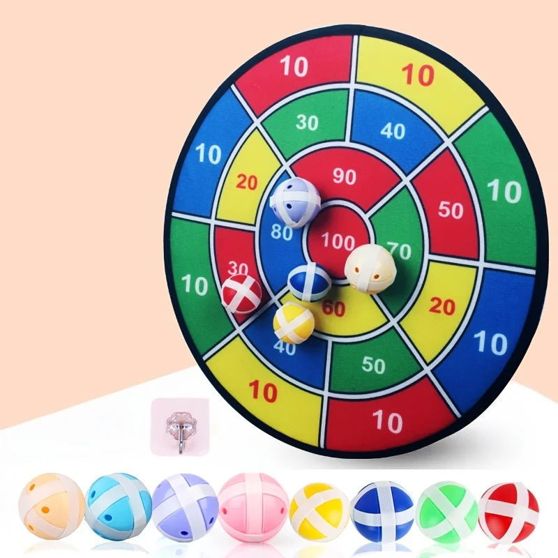 Colorful dartboard game with darts on a light pink background