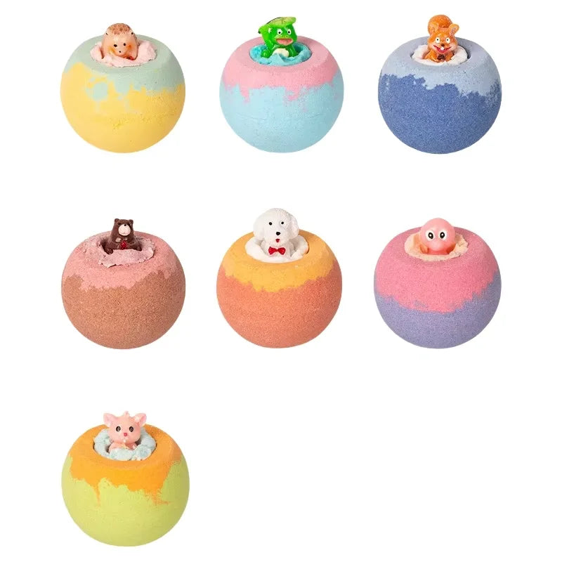 Set of colorful bath bombs with small animal figurines on a white background