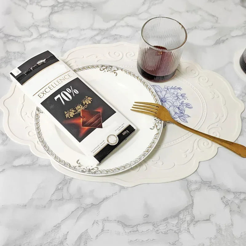 Box of Excellence 70% chocolate on a decorative plate with a glass and fork on a marble surface