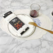 Box of Excellence 70% chocolate on a decorative plate with a glass and fork on a marble surface