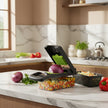 Multifunctional kitchen slicer with various cutting attachments on a white background