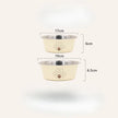 Two pet bowls with paw design, one beige and one silver, on a white background with measurements.