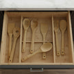 Set of wooden kitchen utensils including spatulas and a fork on a white background