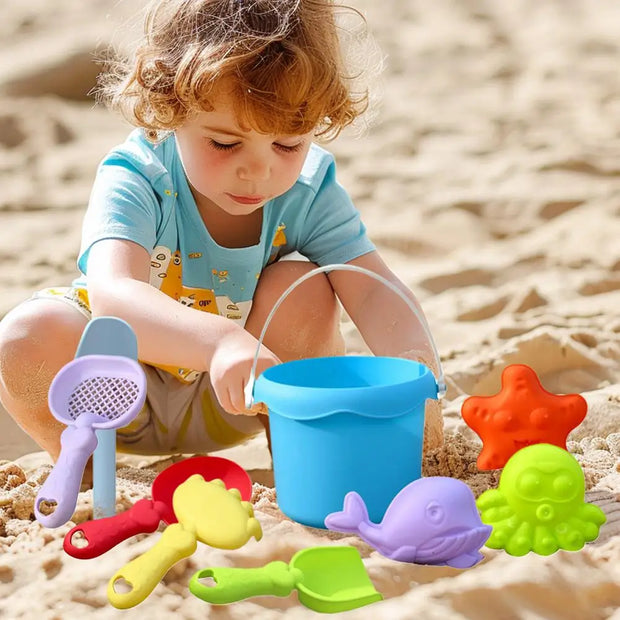 Child playing with colorful sand toys on a sandy beach