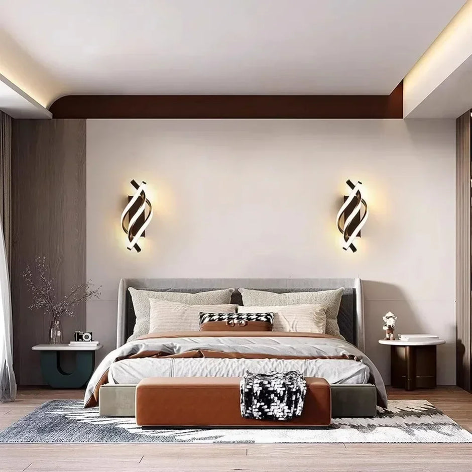 Modern bedroom with a bed, nightstands, and wall sconces.