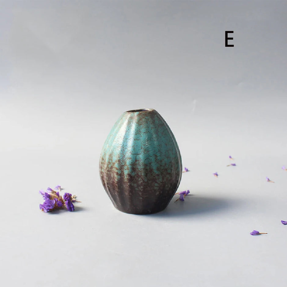 Decorative ceramic vase with a textured surface on a light gray background