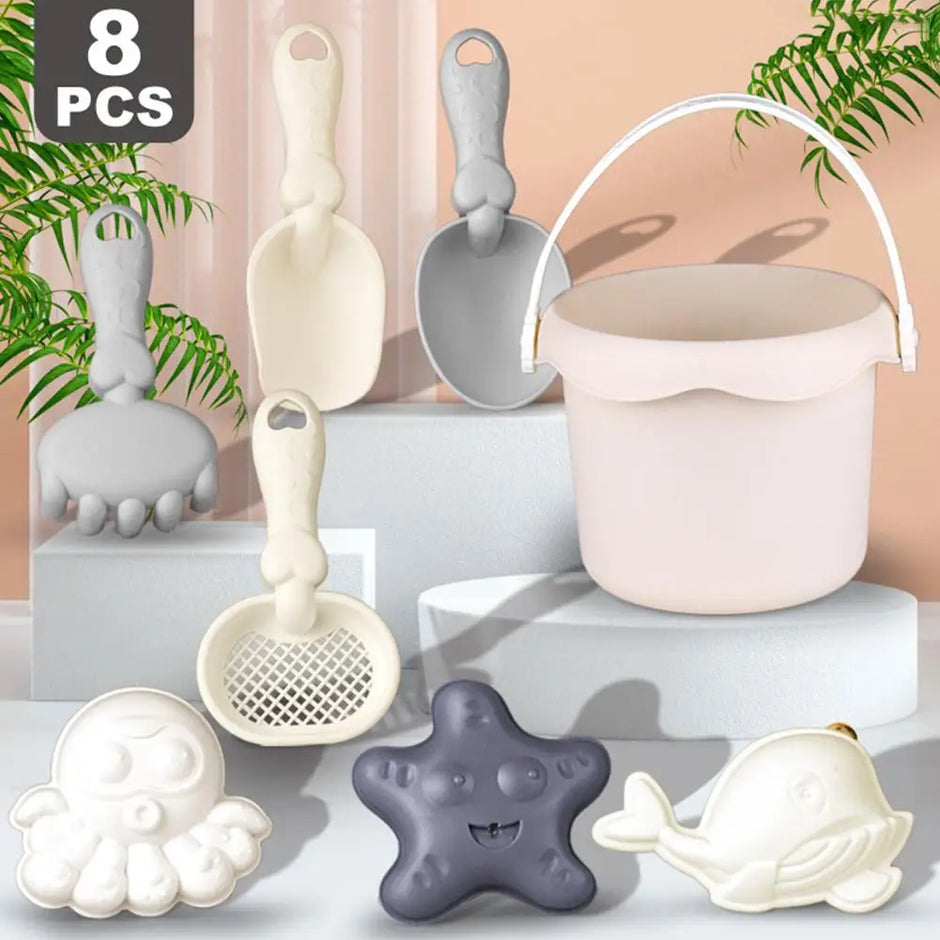 Set of 8 silicone sand toys including a bucket, shovels, and molds on a neutral background.