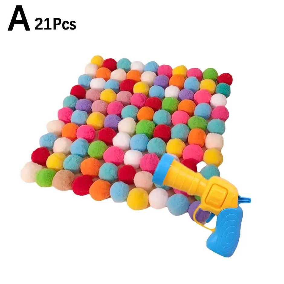 Colorful pom-pom mat with a toy gun on a white background