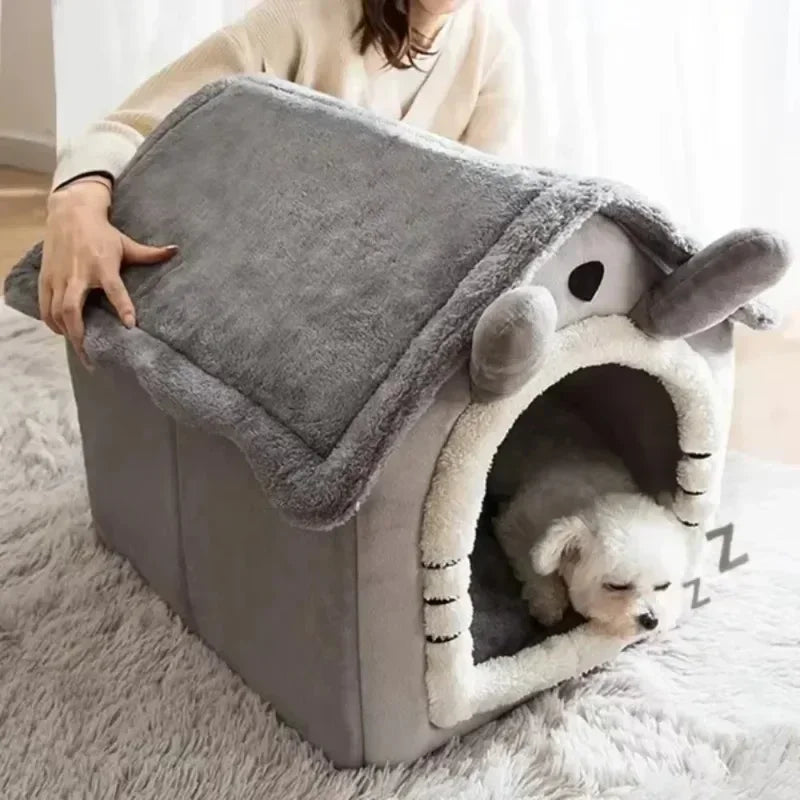 Dog lying inside a gray pet house with a fluffy interior, on a light-colored rug.