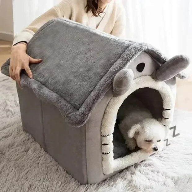 Dog lying inside a gray pet house with a fluffy interior, on a light-colored rug.