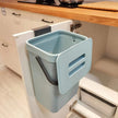 Blue trash bin mounted inside a kitchen cabinet.