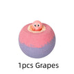 Pink and purple bath bomb with a small pink character on a white background