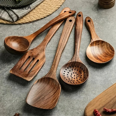 Set of wooden cooking utensils on a gray surface