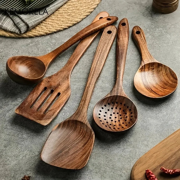 Set of wooden cooking utensils on a gray surface
