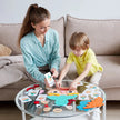 Woman and child playing with craft materials on a glass coffee table