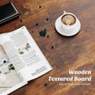 Wooden textured board with an open magazine, coffee cup, and blueberries on a wooden surface.