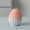 Ceramic vase with gradient color from pink to white on a neutral background