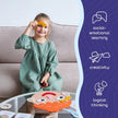Child playing with a puzzle on a table, surrounded by educational elements.