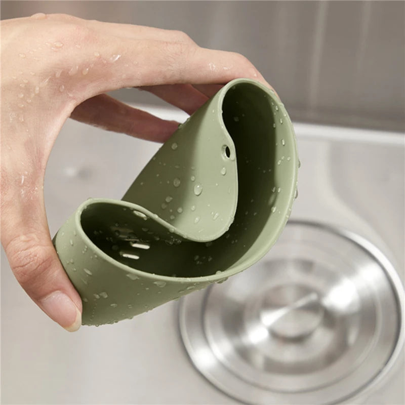Green silicone cup held over a sink