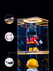 Toy figure in a clear display case with additional toys on a black background