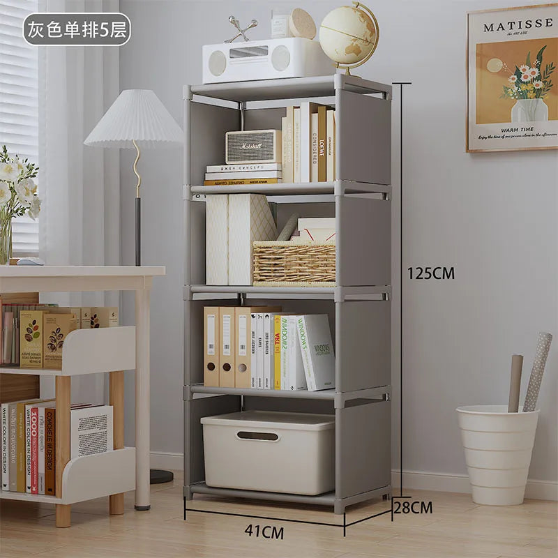 Gray bookshelf with books and decorative items in a room setting, including a lamp and plant.