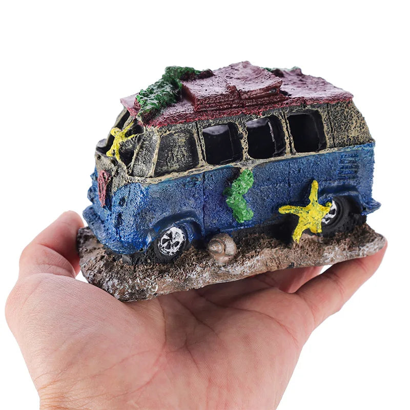 Hand holding a decorative bus figurine on a white background