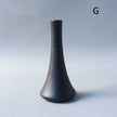 Black textured vase on a gray background
