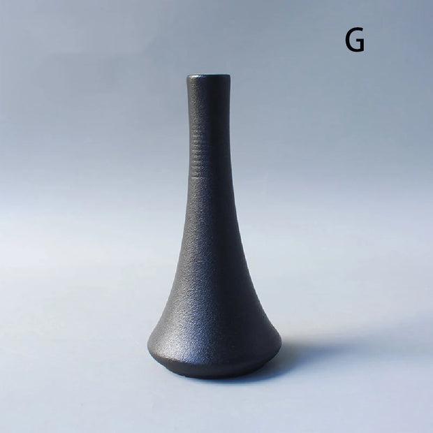 Black textured vase on a gray background