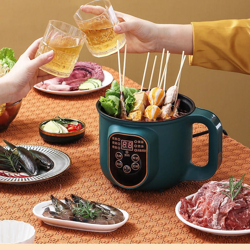 Two people toasting with glasses of beer over a hot pot meal on a table.