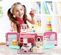 Child playing with a toy dollhouse and teddy bear, with text 'Enjoying Playing' above.