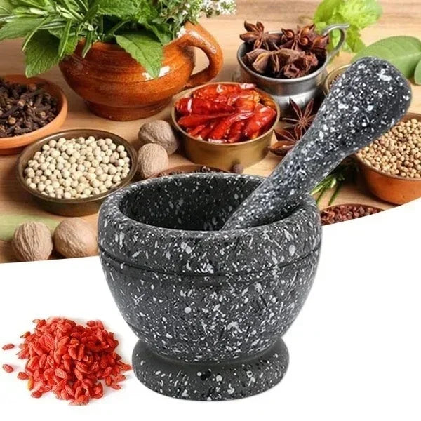 Mortar and pestle with various spices and herbs on a wooden surface