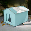 Light blue pet house-shaped box with a clear window on a gray surface.