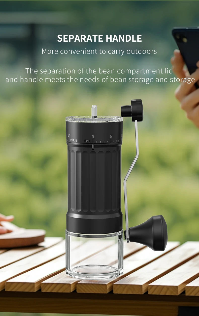 Coffee grinder on a wooden table with a blurred green background