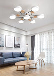 Modern living room with a chandelier, sofa, coffee table, and decorative elements.