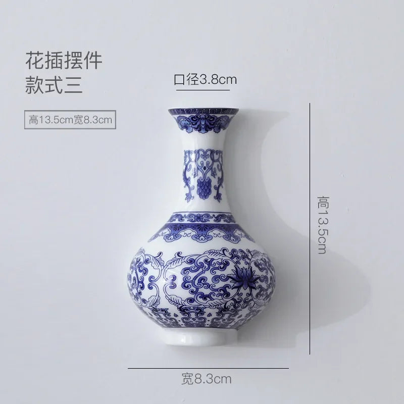 Blue and white ceramic vase with floral patterns and dimensions on a light gray background