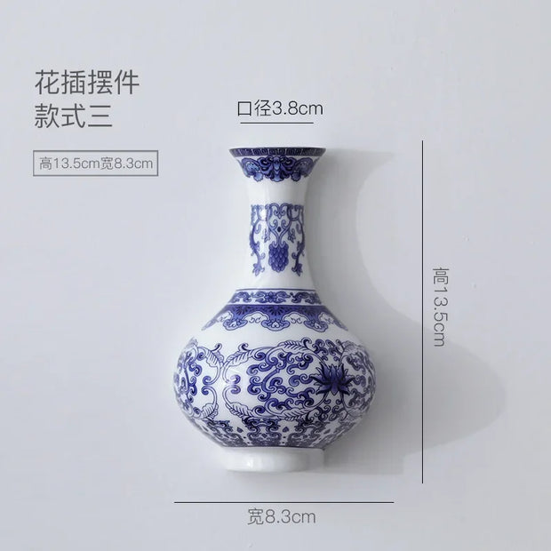Blue and white ceramic vase with floral patterns and dimensions on a light gray background