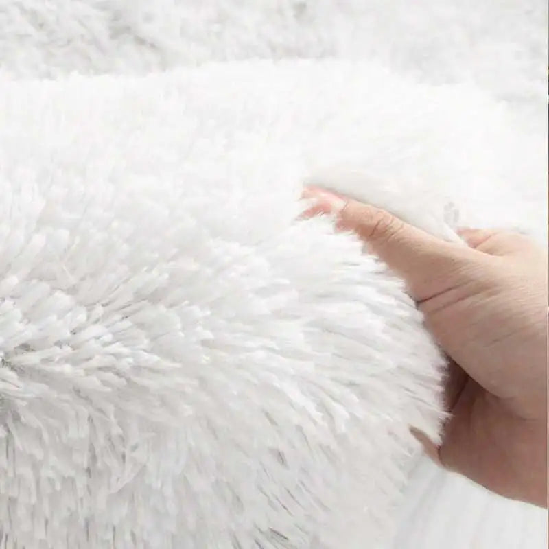 Close-up of white fluffy fabric with a hand touching it