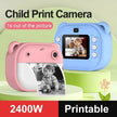 Two children's instant cameras, one pink and one blue, on a green background with text about child print camera features.