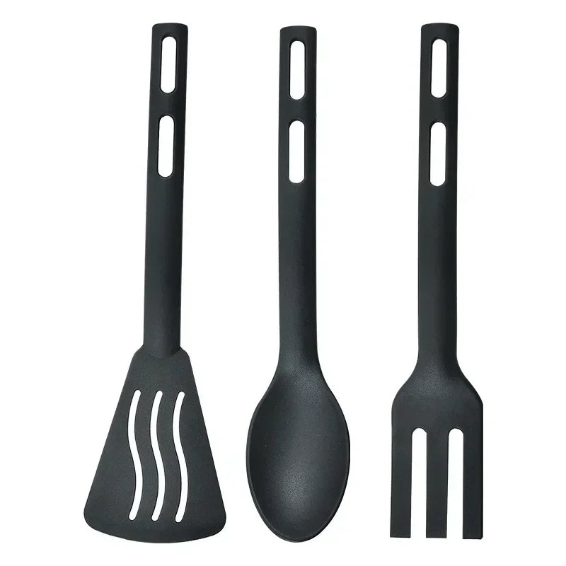Set of three black kitchen utensils on a white background
