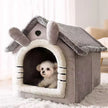 Pet house with a small dog peeking out, placed on a white surface.