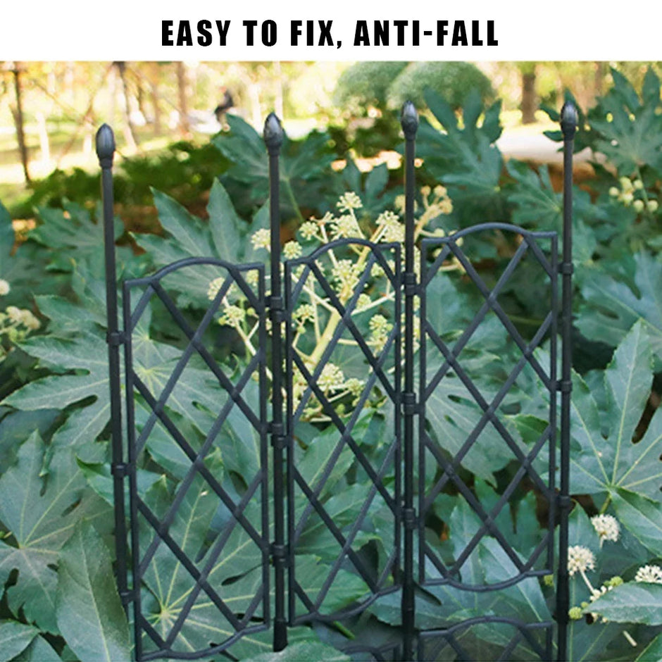 Black metal garden trellis with green plants in the background