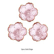 Three pink flower-shaped dishes with gold edges on a white background
