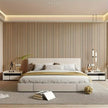 Modern bedroom with a bed, nightstands, and decorative elements.