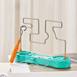 Turquoise cleaning tool with orange handle on a white surface