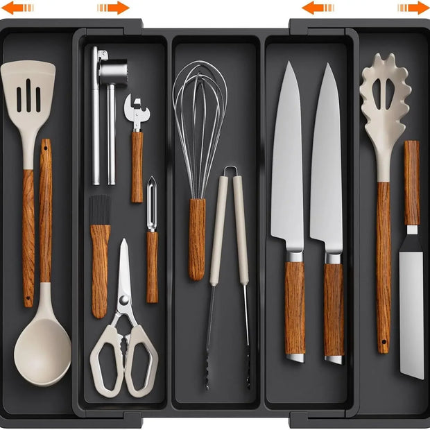Set of kitchen utensils including knives, spoons, and whisks in a black case.