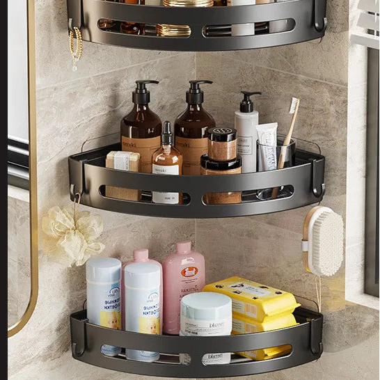 Three-tier corner shelf with bathroom products against a tiled wall.