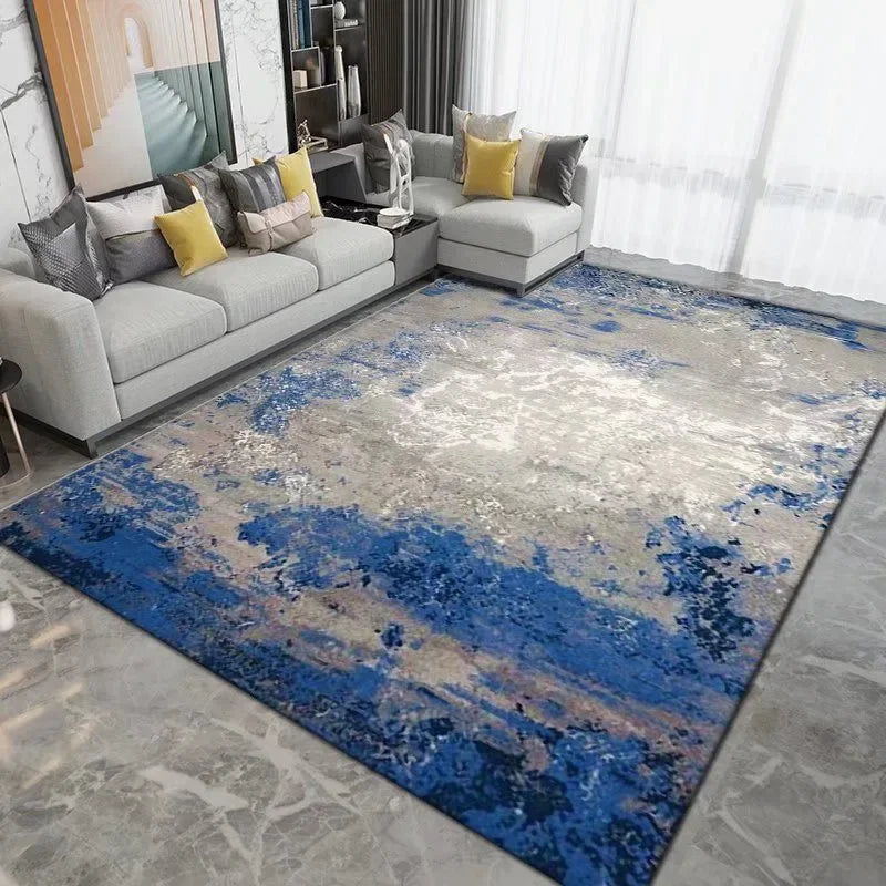 Living room with a blue and gray abstract rug, gray sofa, and yellow pillows.