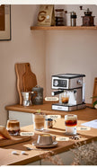 Coffee machine on a wooden counter with various coffee drinks and ingredients.